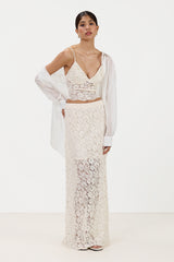 Front view of cream lace maxi skirt with inner lining, paired with a matching lace bra top and a white shirt
