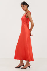 Side view of bright coral satin slip dress